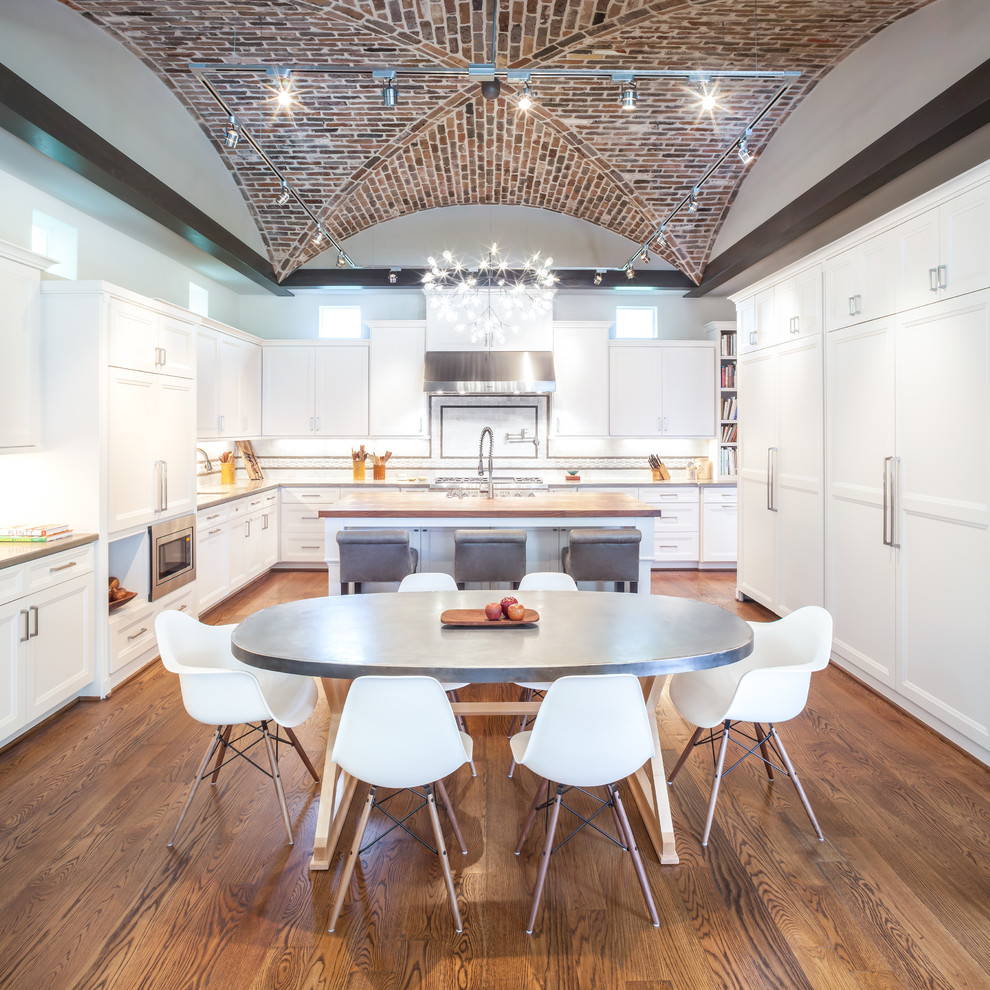 Inspiration for a large classic u-shaped kitchen/diner in Houston with shaker cabinets, white cabinets, wood worktops, white splashback, integrated appliances, medium hardwood flooring and an island.