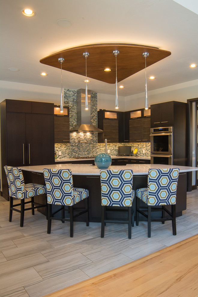 Example of a large arts and crafts l-shaped vinyl floor and gray floor open concept kitchen design in Oklahoma City with a farmhouse sink, flat-panel cabinets, dark wood cabinets, quartz countertops, blue backsplash, mosaic tile backsplash, stainless steel appliances and an island