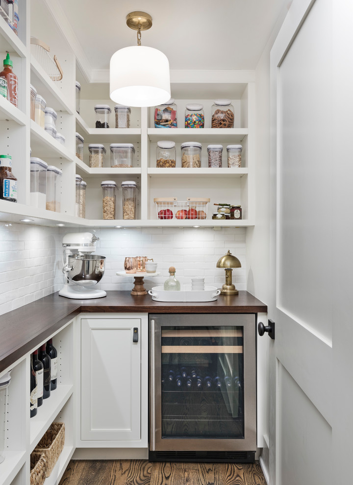 Transitional l-shaped dark wood floor and brown floor kitchen pantry photo in Detroit with open cabinets, white cabinets, wood countertops, white backsplash, stainless steel appliances and brown countertops