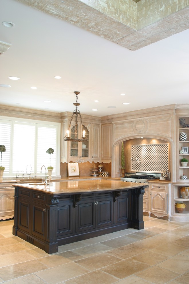 Inspiration for a large timeless u-shaped limestone floor and beige floor eat-in kitchen remodel in Detroit with a farmhouse sink, beaded inset cabinets, light wood cabinets, limestone countertops, black backsplash, stone tile backsplash, paneled appliances and two islands