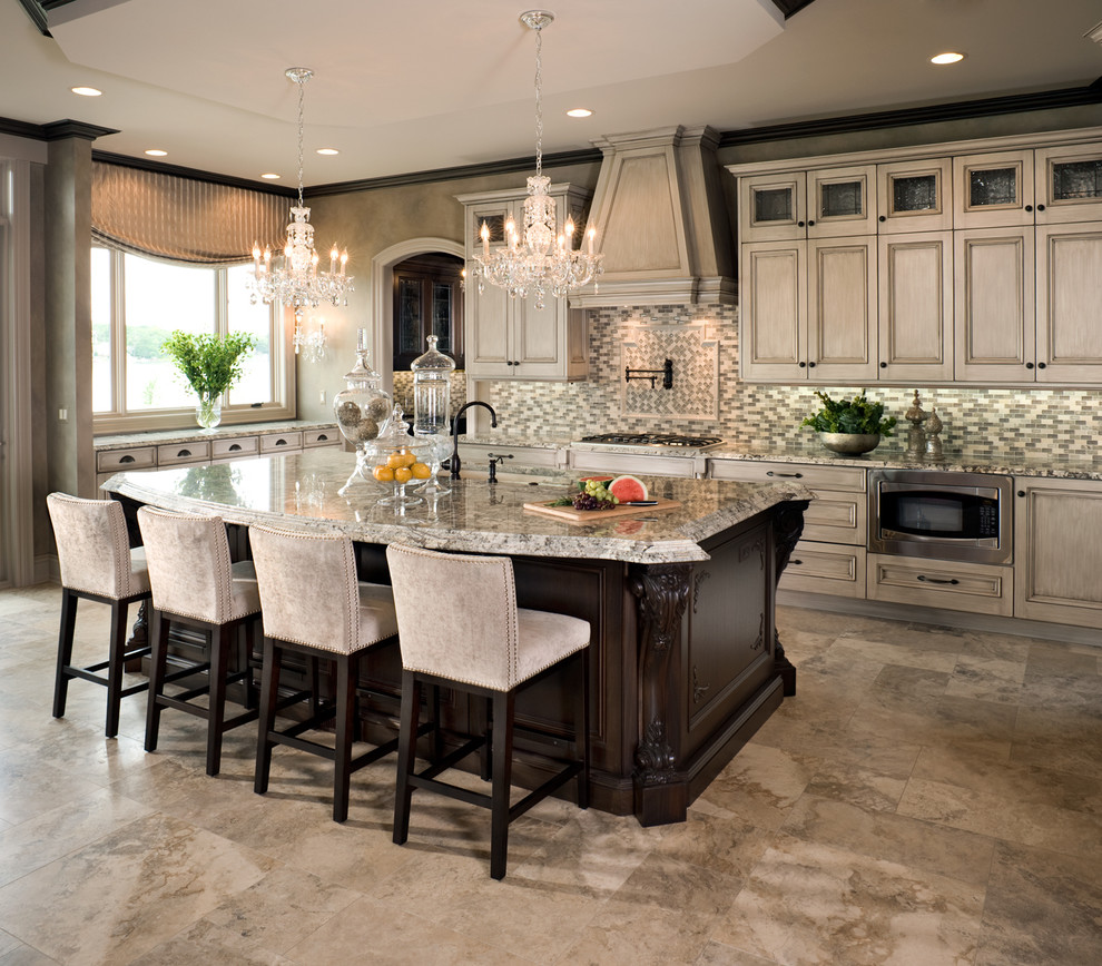 Eat-in kitchen - huge traditional galley travertine floor eat-in kitchen idea in Detroit with recessed-panel cabinets, beige cabinets, granite countertops, beige backsplash, glass tile backsplash, stainless steel appliances and an island