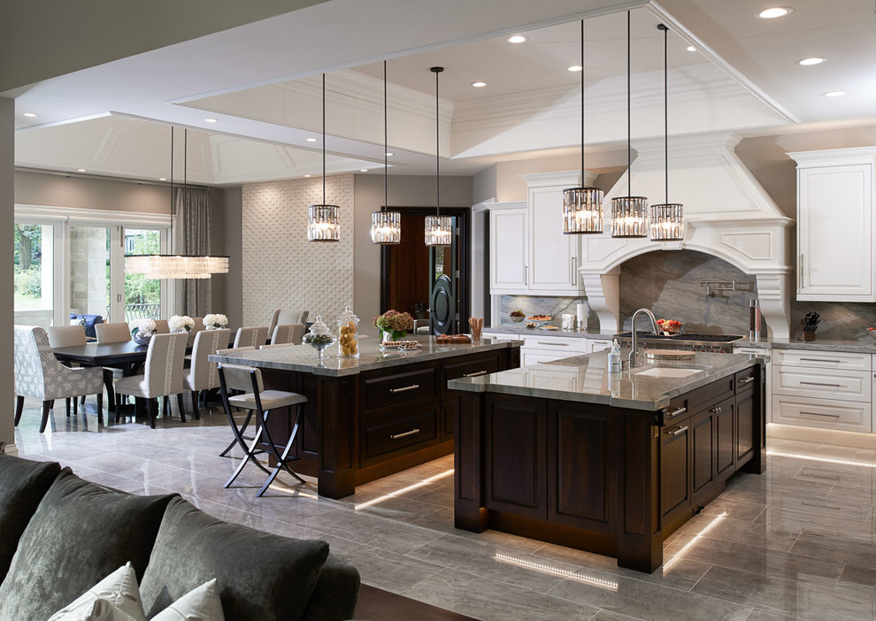 Example of a huge trendy galley porcelain tile eat-in kitchen design in Detroit with an undermount sink, beaded inset cabinets, white cabinets, granite countertops, gray backsplash, stainless steel appliances, two islands and stone slab backsplash