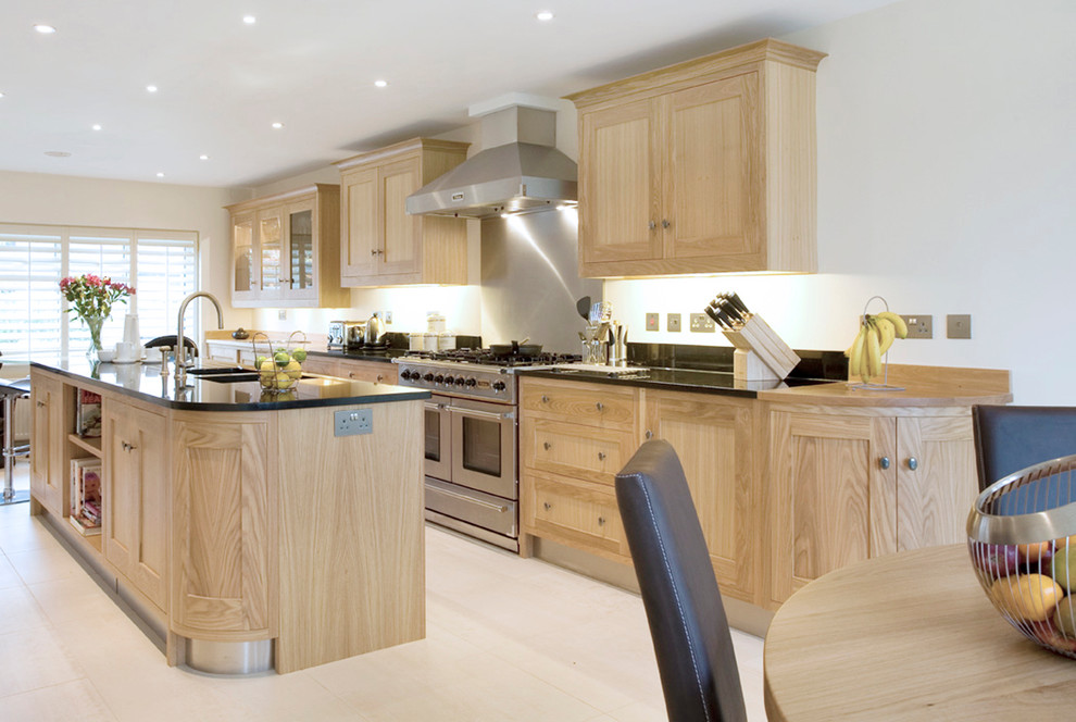 Classic galley kitchen/diner in Essex with a double-bowl sink, shaker cabinets, light wood cabinets, stainless steel appliances and an island.