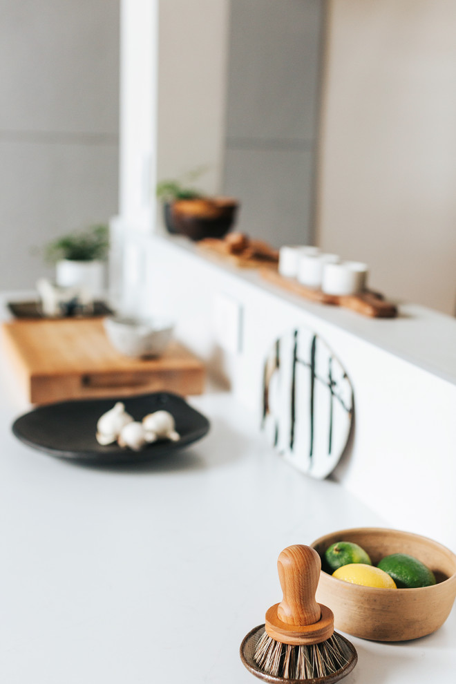 This is an example of a scandi kitchen in San Francisco with white splashback and stone slab splashback.