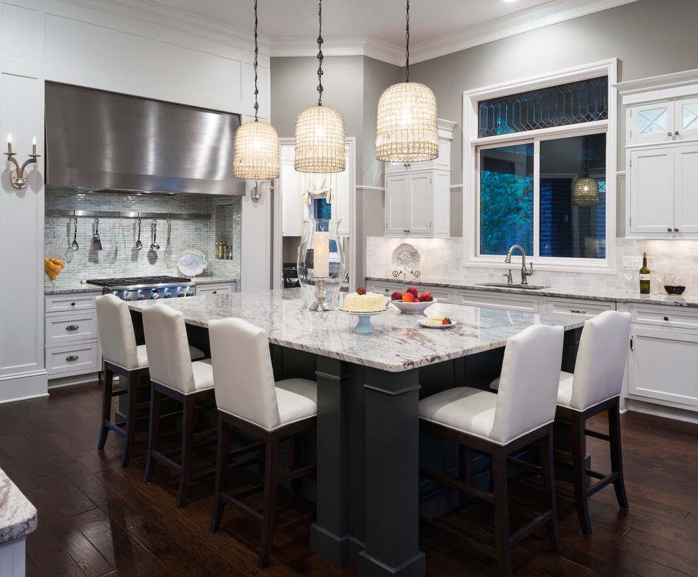 Large transitional galley dark wood floor and brown floor eat-in kitchen photo in Detroit with an undermount sink, shaker cabinets, white cabinets, granite countertops, multicolored backsplash, mosaic tile backsplash, stainless steel appliances and an island