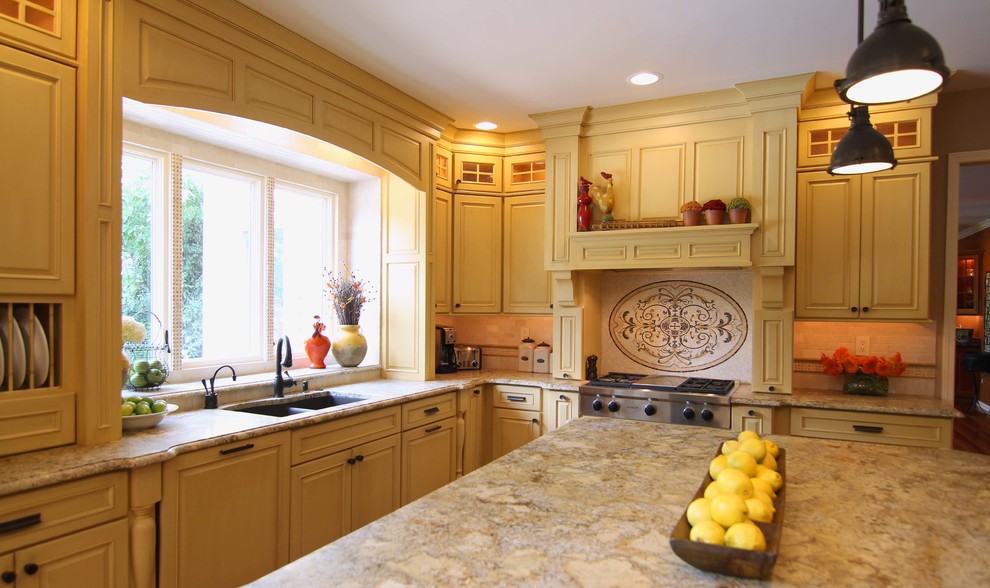 Kitchen - transitional kitchen idea in Detroit with a double-bowl sink, raised-panel cabinets, beige cabinets, granite countertops, beige backsplash, ceramic backsplash, paneled appliances and an island