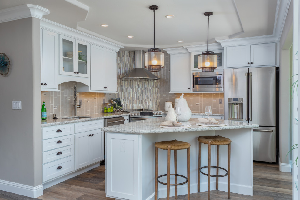 Inspiration for a traditional l-shaped kitchen in San Francisco with a submerged sink, shaker cabinets, white cabinets, grey splashback, stainless steel appliances, dark hardwood flooring, an island, brown floors and grey worktops.