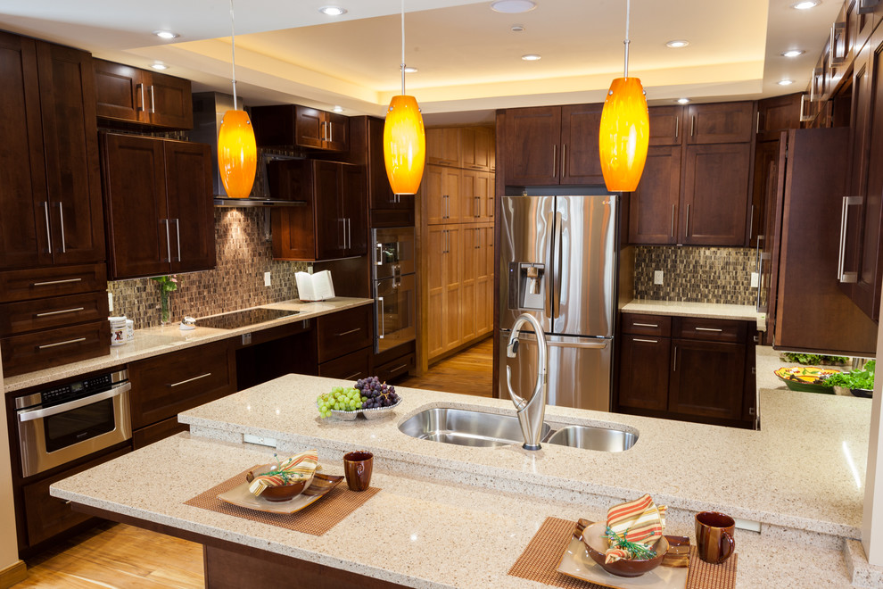 Design ideas for a traditional kitchen in DC Metro with a submerged sink, shaker cabinets, dark wood cabinets, engineered stone countertops, brown splashback, mosaic tiled splashback and stainless steel appliances.