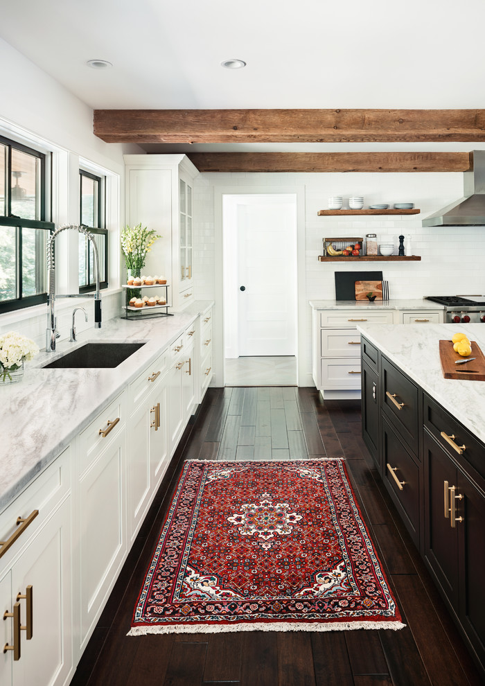 Large farmhouse dark wood floor kitchen photo in New York with a drop-in sink, beaded inset cabinets, white cabinets, marble countertops, white backsplash, subway tile backsplash, stainless steel appliances and an island