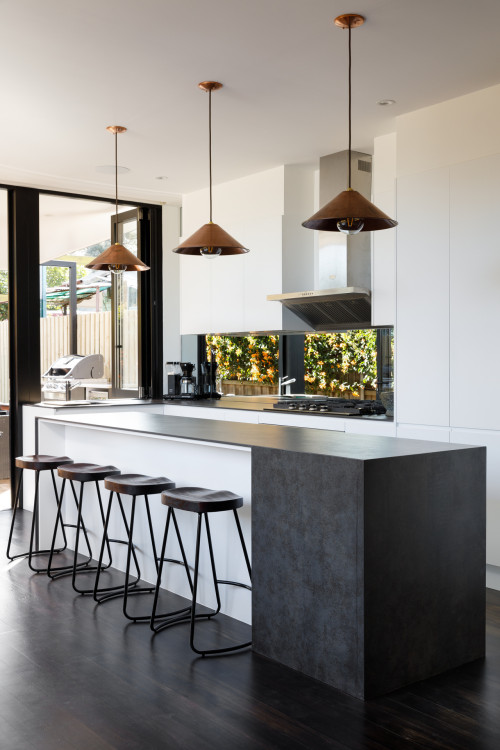 Stunning Backsplash: White Kitchen Cabinets with a Black Countertop and Window Backsplash