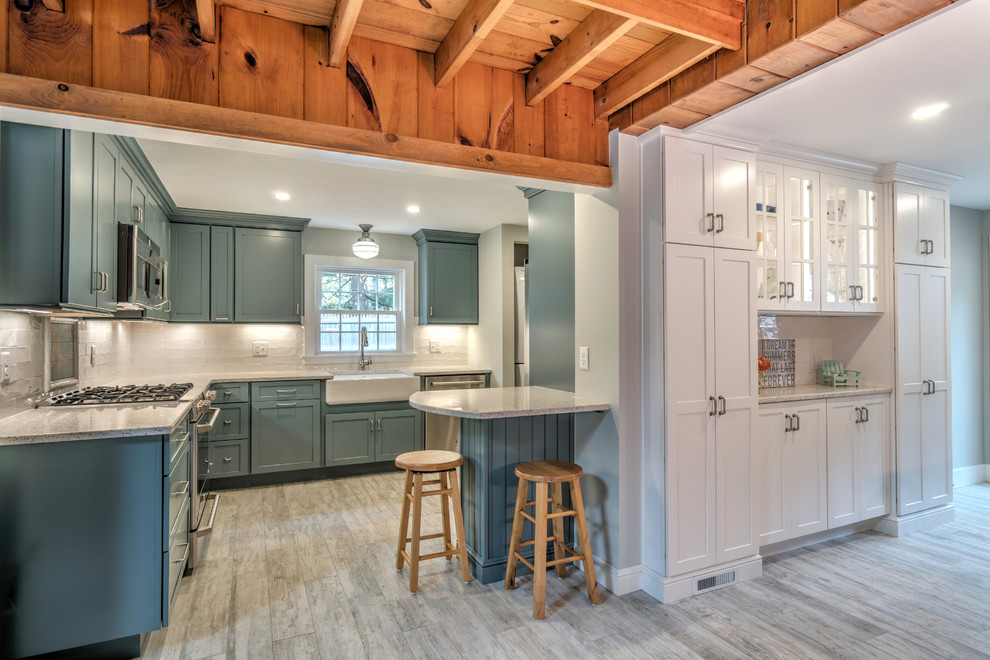 Inspiration for a small modern l-shaped ceramic tile and beige floor kitchen pantry remodel in Boston with a farmhouse sink, shaker cabinets, blue cabinets, recycled glass countertops, white backsplash, ceramic backsplash, stainless steel appliances and an island