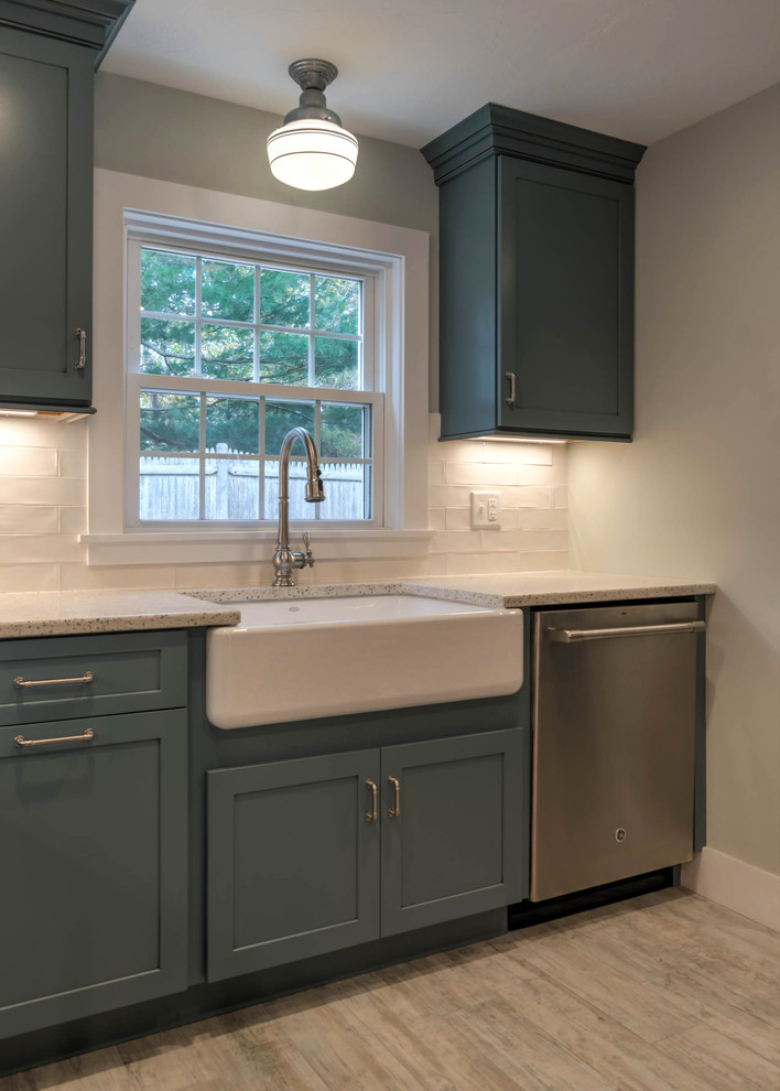 Example of a small minimalist l-shaped ceramic tile and beige floor kitchen pantry design in Boston with a farmhouse sink, shaker cabinets, blue cabinets, recycled glass countertops, white backsplash, ceramic backsplash, stainless steel appliances and an island