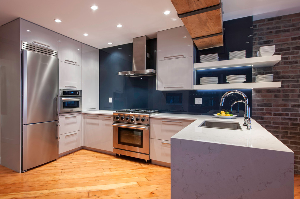 Design ideas for a medium sized contemporary u-shaped open plan kitchen in Vancouver with a double-bowl sink, flat-panel cabinets, white cabinets, quartz worktops, blue splashback, stainless steel appliances, light hardwood flooring and a breakfast bar.