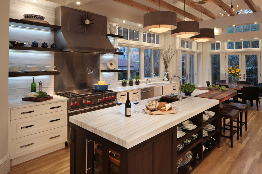 Example of a large classic medium tone wood floor eat-in kitchen design in Denver with an undermount sink, recessed-panel cabinets, white cabinets, stainless steel appliances, an island and stone slab backsplash
