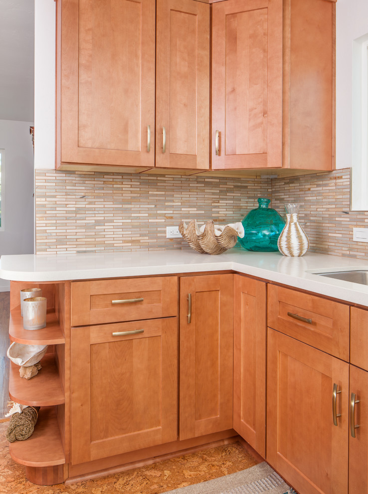 Example of a large transitional l-shaped cork floor eat-in kitchen design in San Diego with an undermount sink, shaker cabinets, medium tone wood cabinets, quartz countertops, stone tile backsplash, white appliances, no island and multicolored backsplash