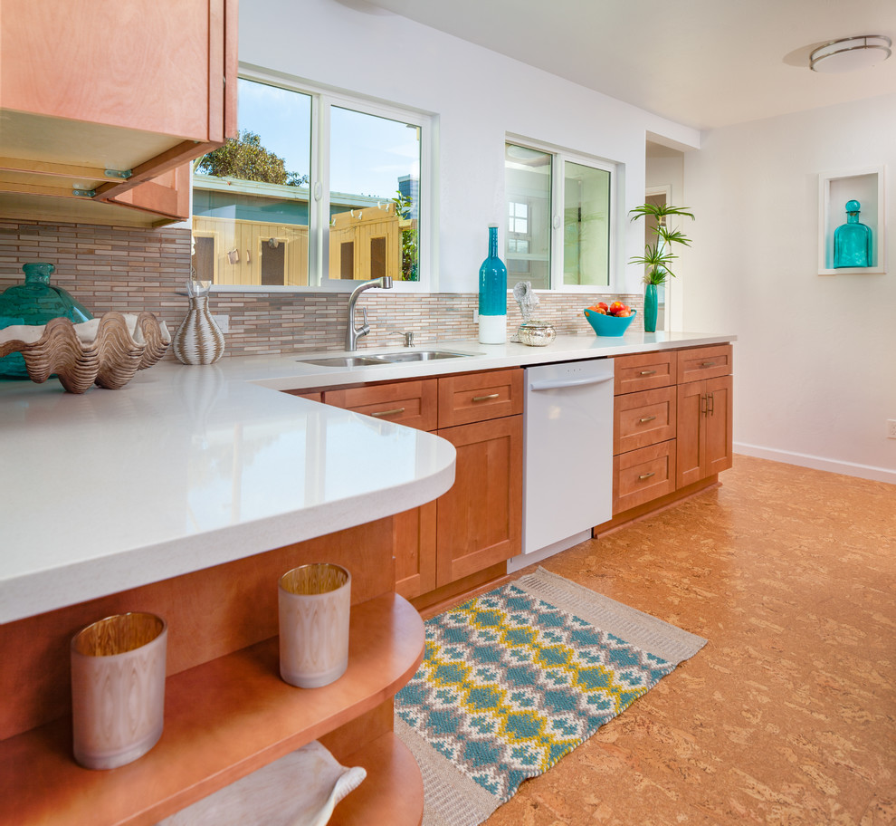 Photo of a large classic l-shaped kitchen/diner in San Diego with a submerged sink, shaker cabinets, medium wood cabinets, engineered stone countertops, stone tiled splashback, white appliances, cork flooring, no island and multi-coloured splashback.
