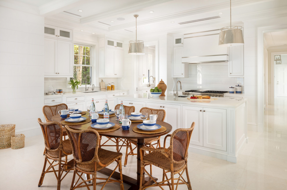 Island style l-shaped white floor eat-in kitchen photo in Miami with an undermount sink, recessed-panel cabinets, white cabinets, white backsplash, stainless steel appliances, an island and white countertops