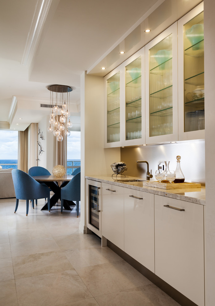 Open concept kitchen - large contemporary l-shaped beige floor open concept kitchen idea in Miami with an undermount sink, flat-panel cabinets, medium tone wood cabinets, stone slab backsplash, paneled appliances and an island