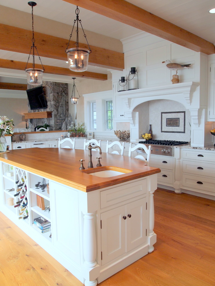 Classic kitchen in Portland Maine with wood worktops, white cabinets and stainless steel appliances.