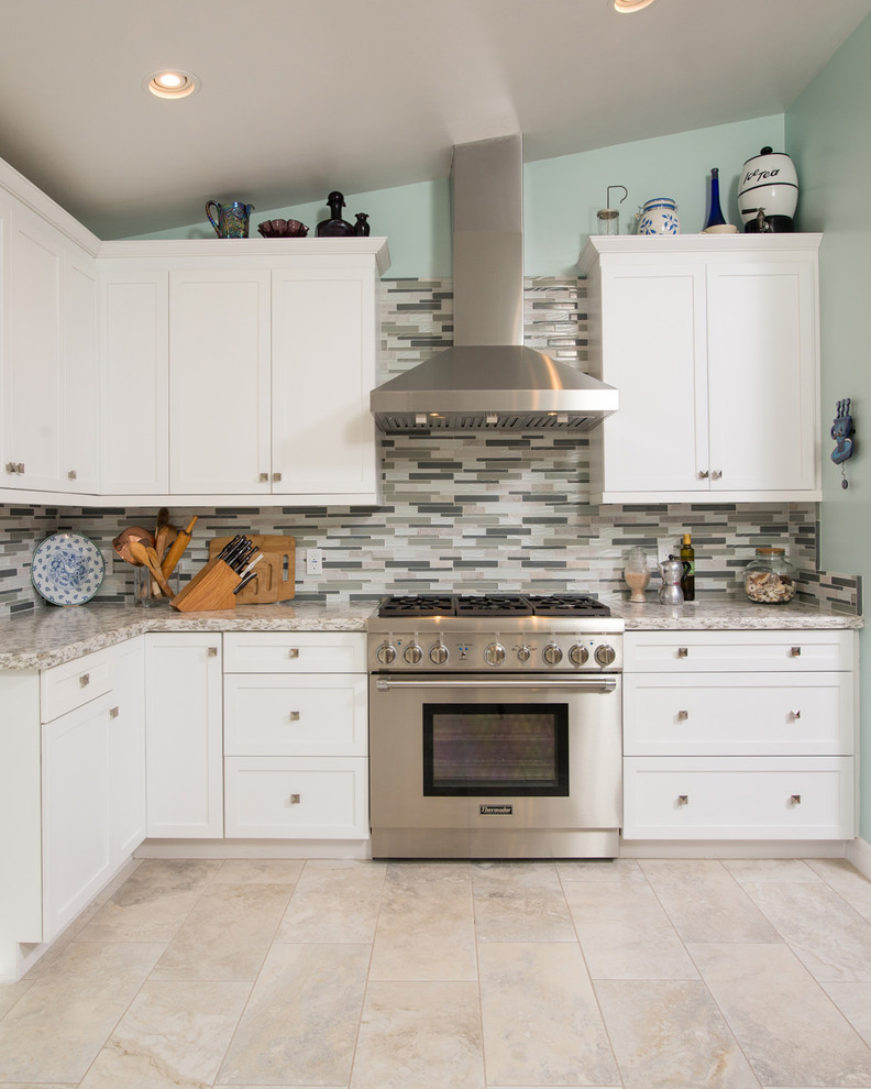 Large elegant u-shaped ceramic tile eat-in kitchen photo in San Diego with a drop-in sink, raised-panel cabinets, white cabinets, quartzite countertops, gray backsplash, glass tile backsplash, stainless steel appliances and a peninsula