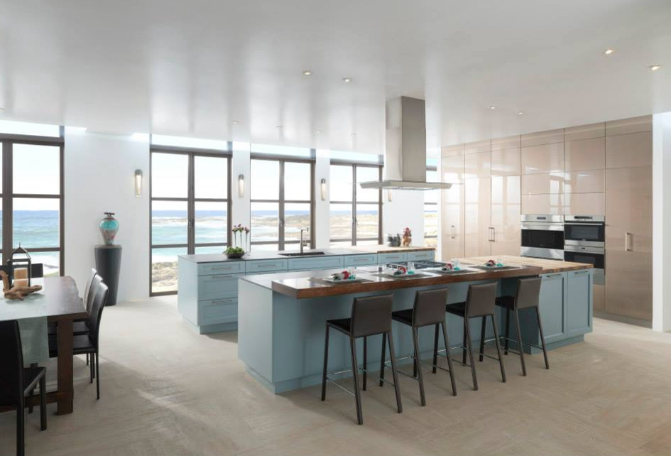 Eat-in kitchen - large contemporary l-shaped ceramic tile eat-in kitchen idea in Houston with recessed-panel cabinets, blue cabinets, wood countertops, stainless steel appliances and two islands