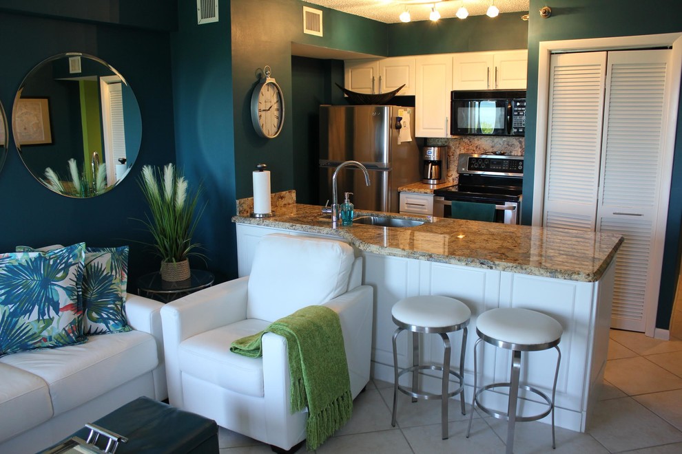Example of a small island style single-wall ceramic tile and beige floor open concept kitchen design in Boston with an undermount sink, raised-panel cabinets, white cabinets, granite countertops, brown backsplash, stone slab backsplash, stainless steel appliances, a peninsula and brown countertops