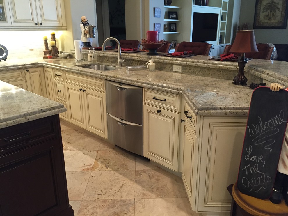 Example of a mid-sized trendy u-shaped kitchen design in Miami with a single-bowl sink, raised-panel cabinets, white cabinets, granite countertops, stainless steel appliances and an island