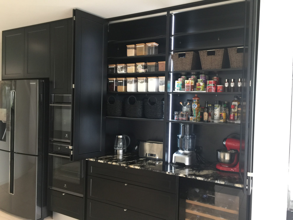 This is an example of a large modern kitchen pantry in Sunshine Coast with a submerged sink, shaker cabinets, black cabinets, granite worktops, granite splashback, black appliances and an island.