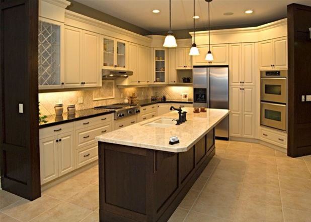 This is an example of a large traditional l-shaped open plan kitchen in Vancouver with a submerged sink, recessed-panel cabinets, white cabinets, granite worktops, beige splashback, stone tiled splashback, stainless steel appliances, limestone flooring and an island.