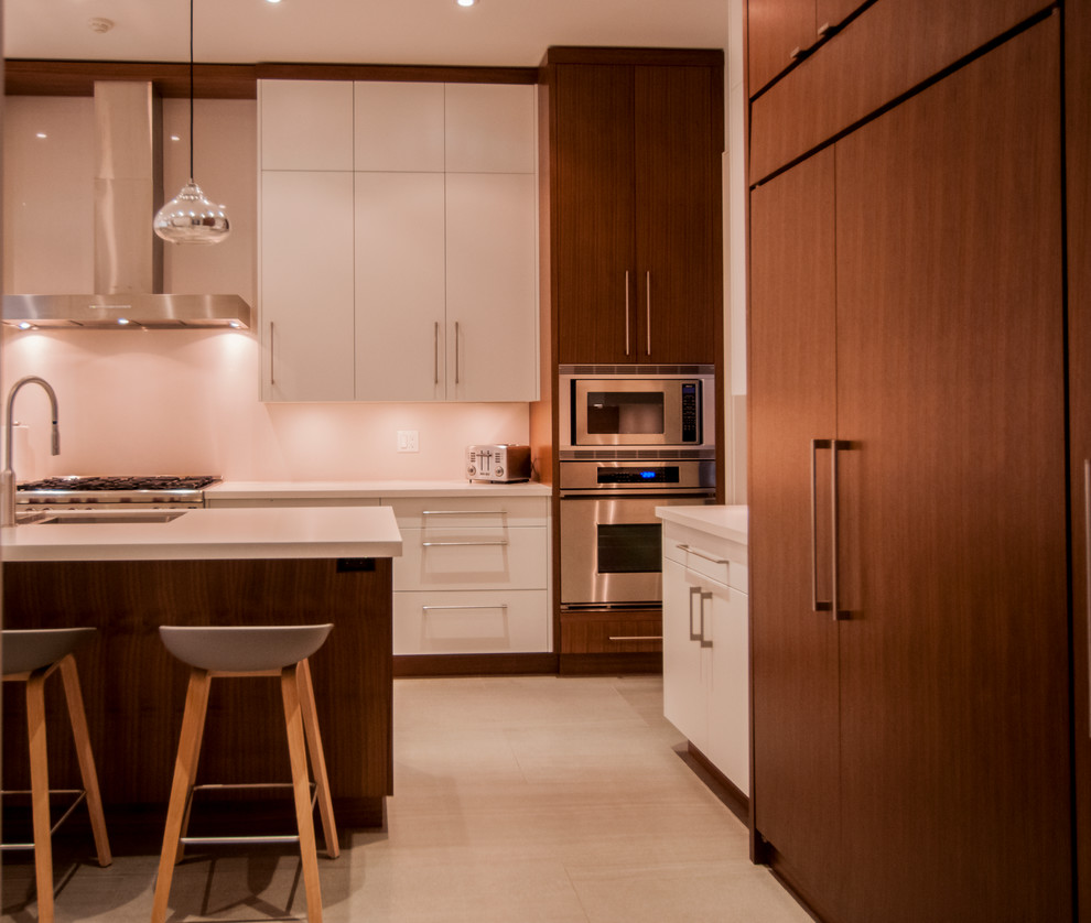 Photo of a large modern u-shaped open plan kitchen in Toronto with a submerged sink, flat-panel cabinets, white cabinets, stainless steel appliances, ceramic flooring, an island, granite worktops, white splashback and stone slab splashback.