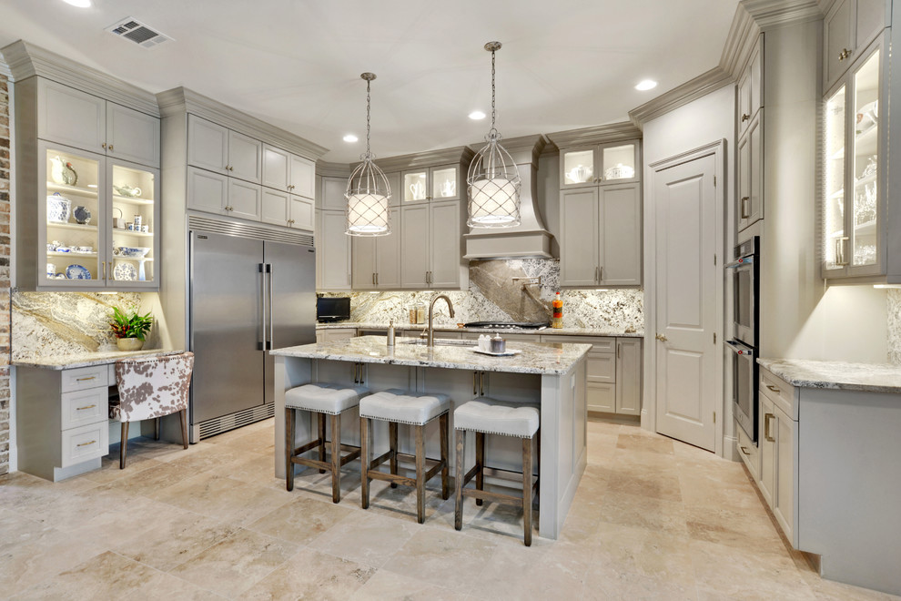 Example of a large transitional u-shaped travertine floor and beige floor open concept kitchen design in New Orleans with an undermount sink, recessed-panel cabinets, beige cabinets, granite countertops, beige backsplash, marble backsplash, stainless steel appliances and an island