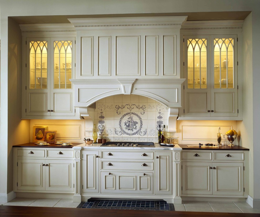 Kitchen in Boston with multi-coloured splashback, raised-panel cabinets and beige cabinets.