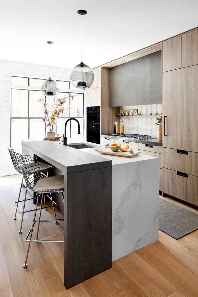 Design ideas for a contemporary galley kitchen in DC Metro with a submerged sink, flat-panel cabinets, medium wood cabinets, white splashback, integrated appliances, medium hardwood flooring, an island, brown floors and white worktops.