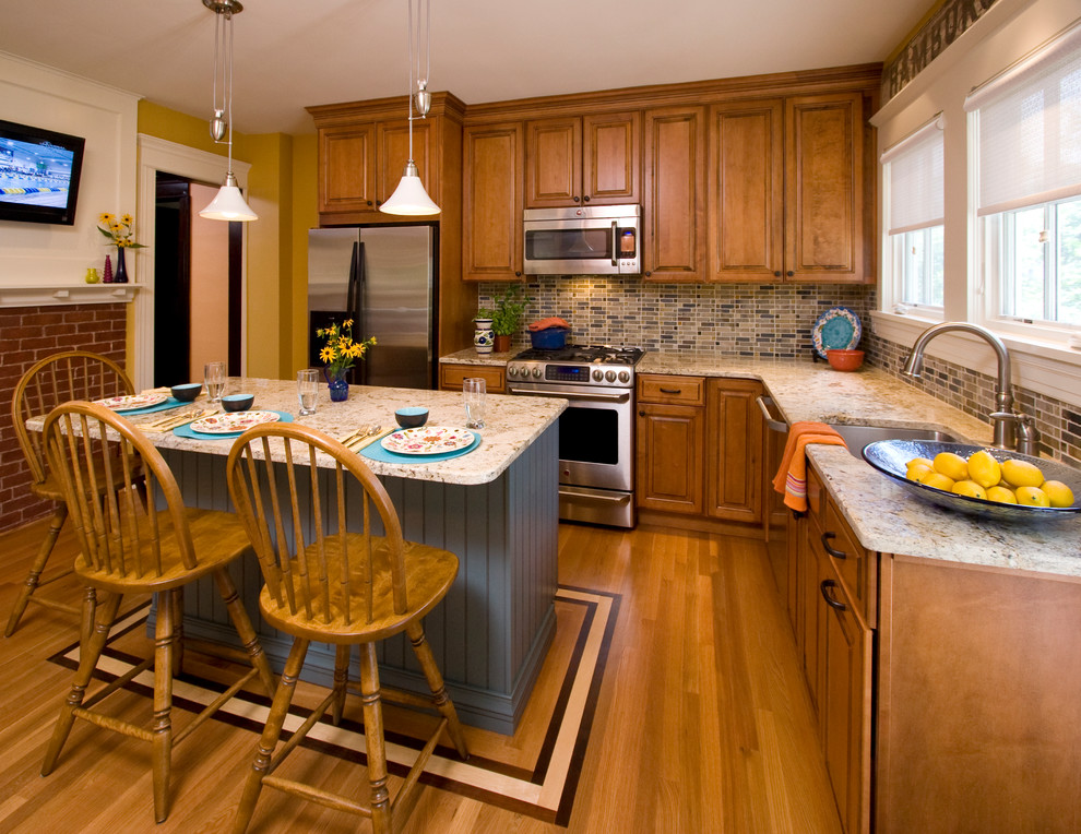 Small elegant l-shaped light wood floor enclosed kitchen photo in New York with an undermount sink, raised-panel cabinets, medium tone wood cabinets, granite countertops, multicolored backsplash, ceramic backsplash, stainless steel appliances and an island