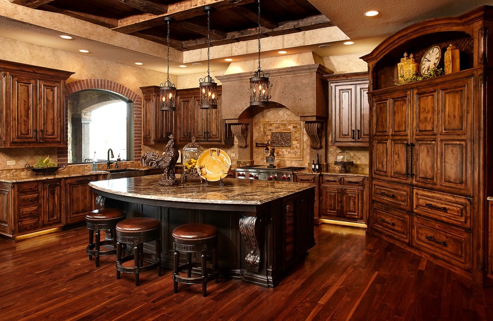 Bild på ett stort medelhavsstil kök, med en rustik diskho, luckor med upphöjd panel, skåp i mellenmörkt trä, granitbänkskiva, brunt stänkskydd, stänkskydd i stenkakel, integrerade vitvaror, mörkt trägolv, en köksö och brunt golv