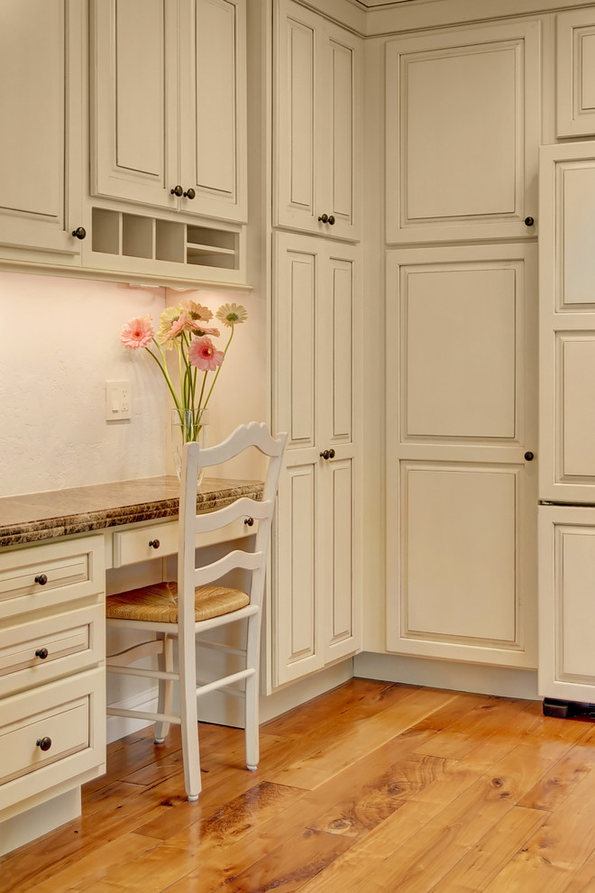 This is an example of a classic kitchen in San Francisco with raised-panel cabinets and white cabinets.