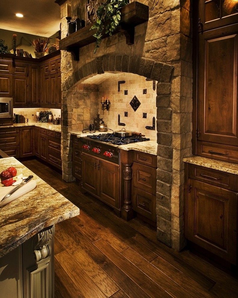 Example of a large ornate l-shaped dark wood floor eat-in kitchen design in Orlando with a farmhouse sink, raised-panel cabinets, dark wood cabinets, granite countertops, beige backsplash, stone tile backsplash, stainless steel appliances and an island