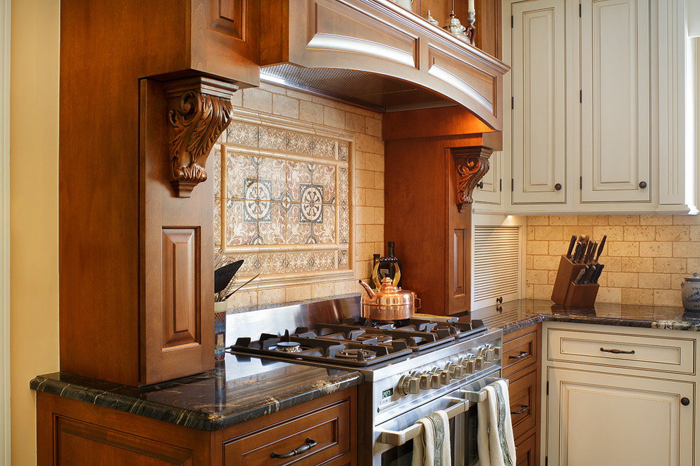 Eat-in kitchen - large traditional l-shaped medium tone wood floor eat-in kitchen idea in Richmond with an undermount sink, beaded inset cabinets, medium tone wood cabinets, granite countertops, beige backsplash, stone tile backsplash, stainless steel appliances and an island