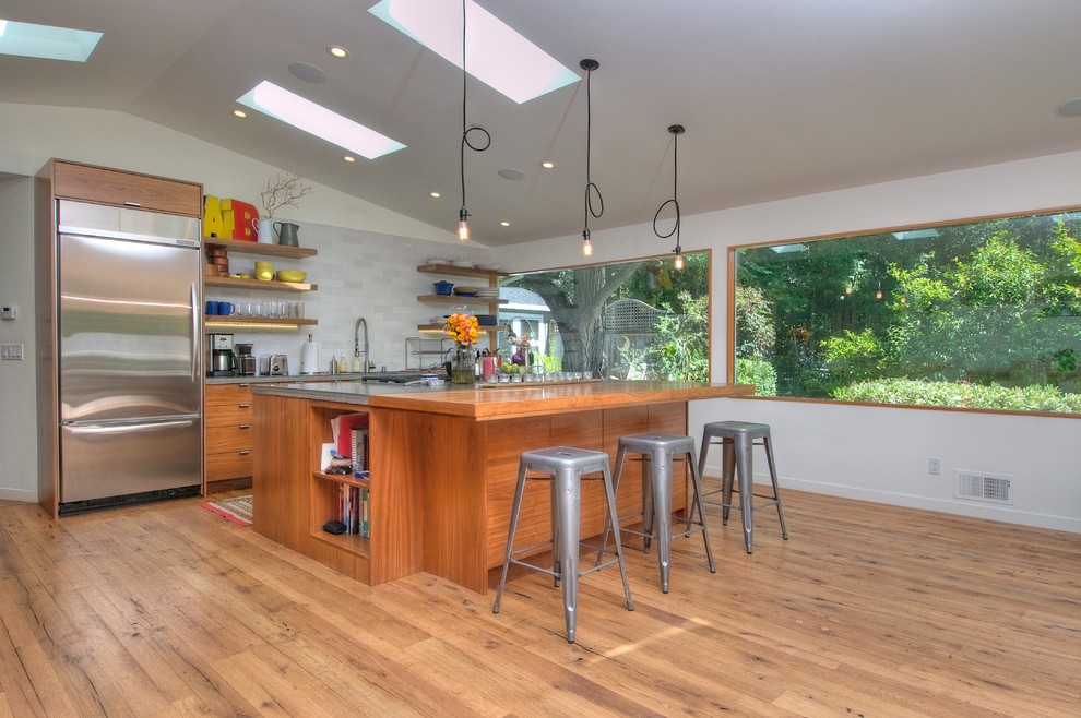 Foto di una cucina parallela moderna con nessun'anta, ante in legno scuro, paraspruzzi grigio e elettrodomestici in acciaio inossidabile