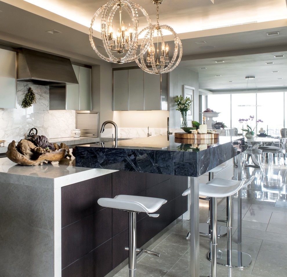 Inspiration for a contemporary u-shaped limestone floor eat-in kitchen remodel in Austin with an undermount sink, flat-panel cabinets, stainless steel cabinets, quartzite countertops, white backsplash, stone slab backsplash, paneled appliances and an island