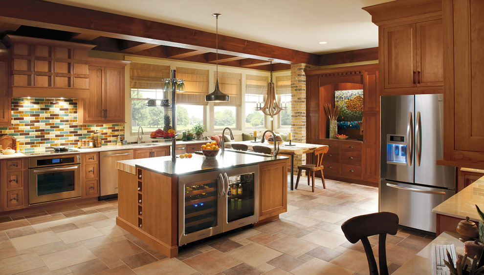 Example of a classic ceramic tile eat-in kitchen design in Other with recessed-panel cabinets, medium tone wood cabinets, granite countertops, multicolored backsplash, glass tile backsplash, stainless steel appliances and an island