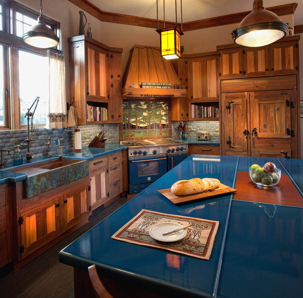 Inspiration for a large classic u-shaped enclosed kitchen in Charleston with a belfast sink, raised-panel cabinets, medium wood cabinets, multi-coloured splashback, mosaic tiled splashback, integrated appliances and an island.