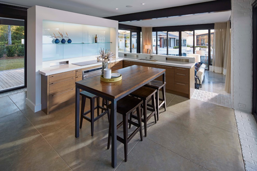 Small trendy l-shaped concrete floor open concept kitchen photo in Wilmington with an undermount sink, flat-panel cabinets, light wood cabinets, quartzite countertops, blue backsplash, glass sheet backsplash and an island