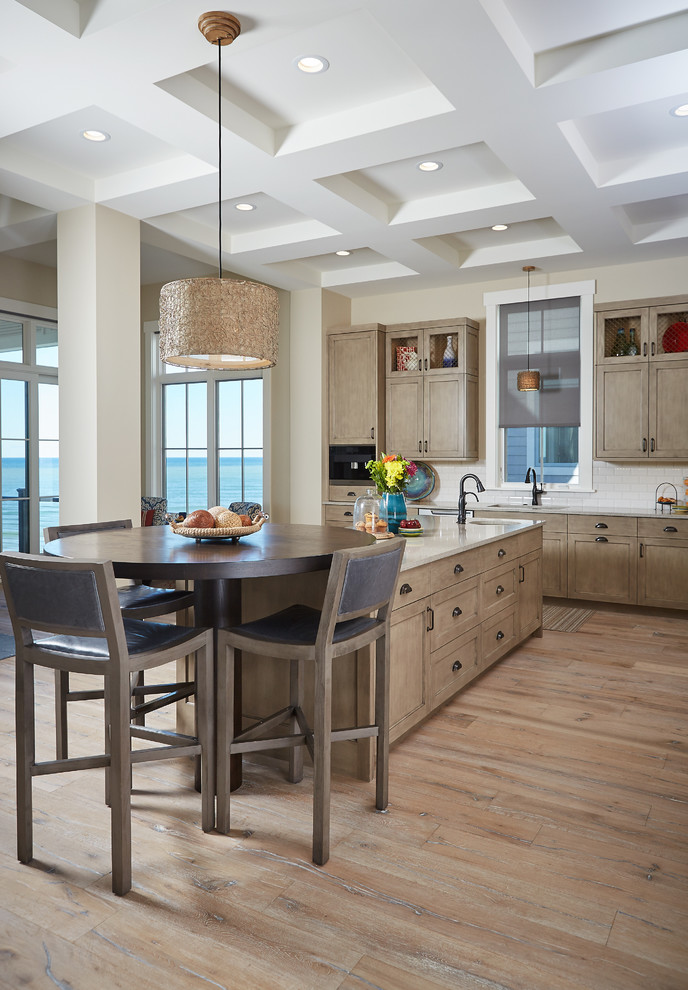Mid-sized transitional l-shaped light wood floor eat-in kitchen photo in Grand Rapids with an undermount sink, shaker cabinets, light wood cabinets, white backsplash, subway tile backsplash, an island, granite countertops and paneled appliances