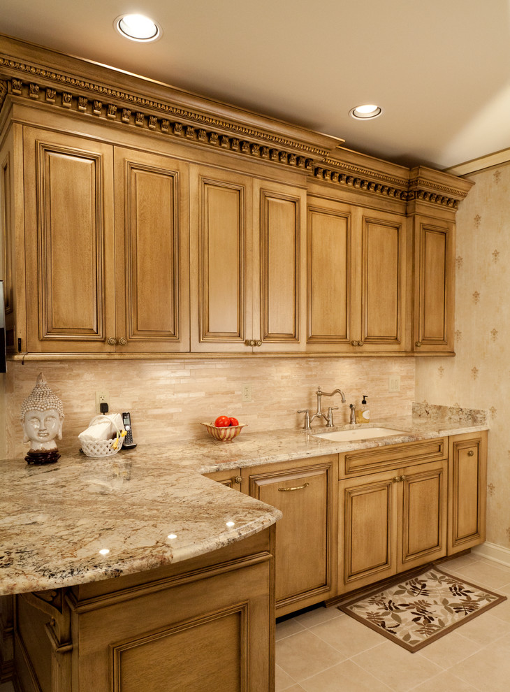 Example of a small classic galley ceramic tile and beige floor eat-in kitchen design in New York with an undermount sink, raised-panel cabinets, beige cabinets, granite countertops, beige backsplash, ceramic backsplash, stainless steel appliances and no island