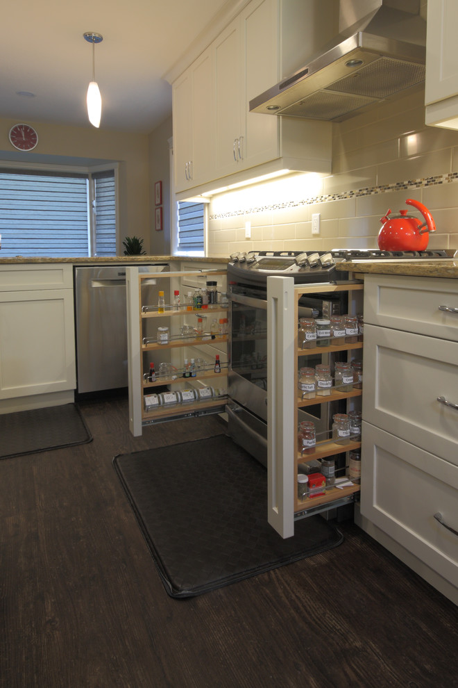 Inspiration for a mid-sized contemporary u-shaped dark wood floor and brown floor eat-in kitchen remodel in Other with an undermount sink, shaker cabinets, white cabinets, granite countertops, stainless steel appliances, an island and white backsplash