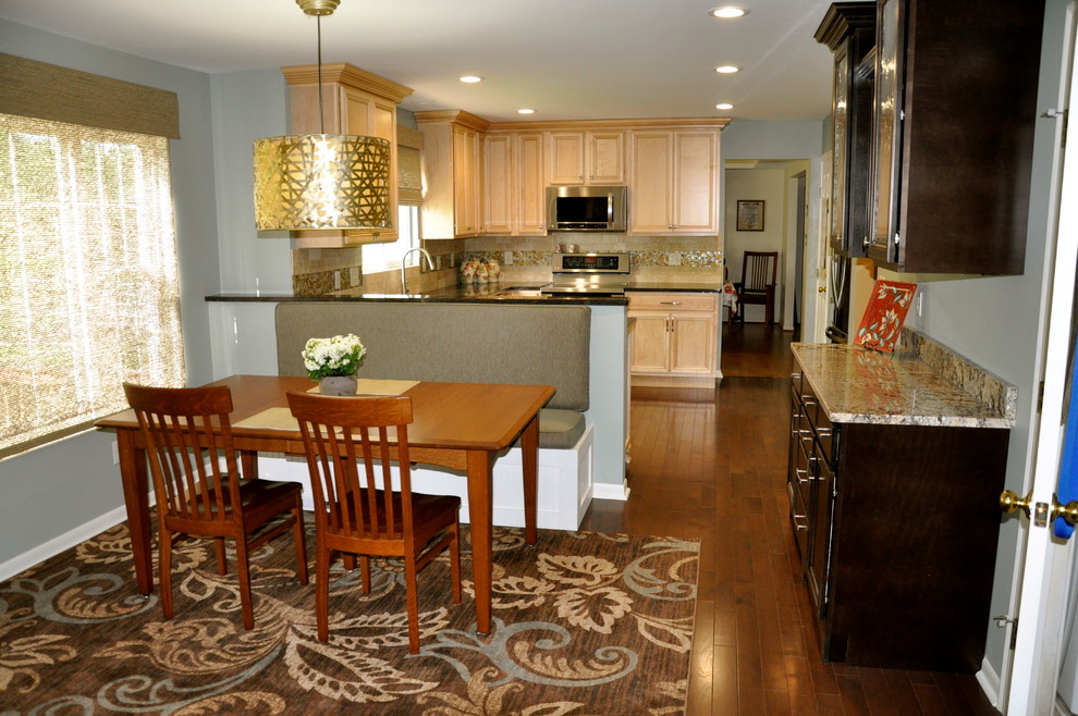 This is an example of a medium sized classic single-wall kitchen/diner in Cincinnati with a submerged sink, black cabinets, granite worktops, beige splashback, mosaic tiled splashback, stainless steel appliances and dark hardwood flooring.