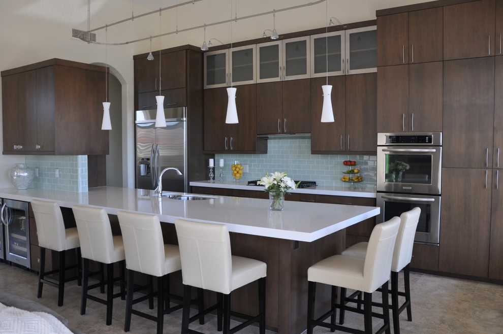 Inspiration for a large contemporary porcelain tile eat-in kitchen remodel in Chicago with an undermount sink, flat-panel cabinets, dark wood cabinets, solid surface countertops, glass tile backsplash, stainless steel appliances and a peninsula