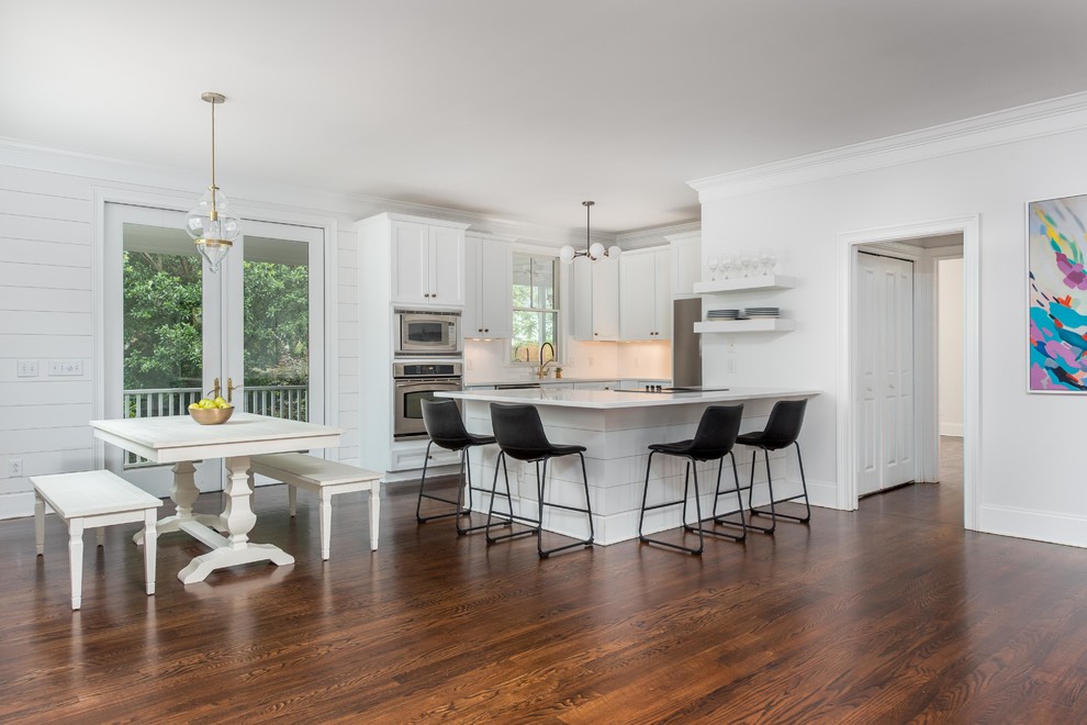Inspiration for a huge modern single-wall dark wood floor and brown floor open concept kitchen remodel in Charleston with an undermount sink, shaker cabinets, white cabinets, quartz countertops, white backsplash, porcelain backsplash, stainless steel appliances, an island and white countertops