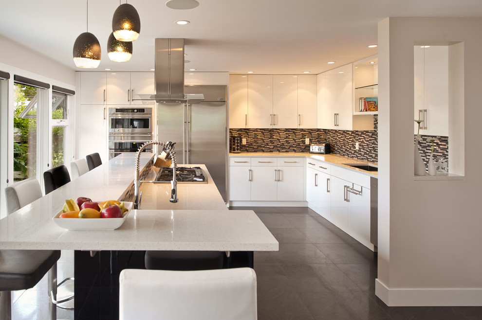 Inspiration for a mid-sized modern l-shaped porcelain tile eat-in kitchen remodel in Vancouver with an undermount sink, flat-panel cabinets, white cabinets, quartz countertops, multicolored backsplash and stainless steel appliances